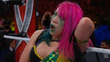 Asuka holds her head in pain - possibly thinking about her WrestleMania win-loss record...
