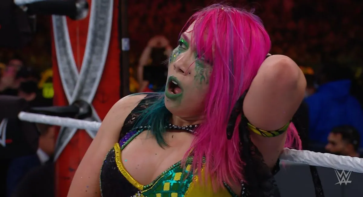 Asuka holds her head in pain - possibly thinking about her WrestleMania win-loss record...