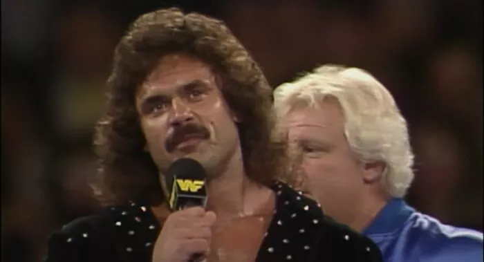 Ravishing Rick Rude addresses the audience as Bobby Heenan looks on