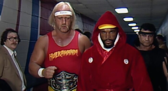 Mr T and Hulk Hogan make their way backstage to the entrance for WrestleMania I