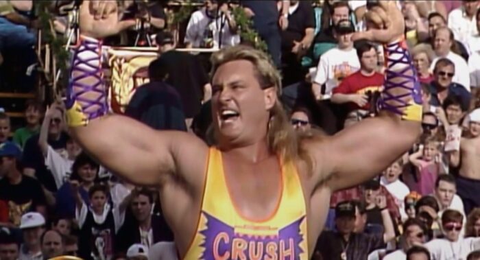 Crush holds up those crushing hands at WrestleMania IX