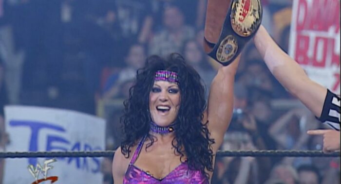 Chyna holds up the WWF Women's Championship belt