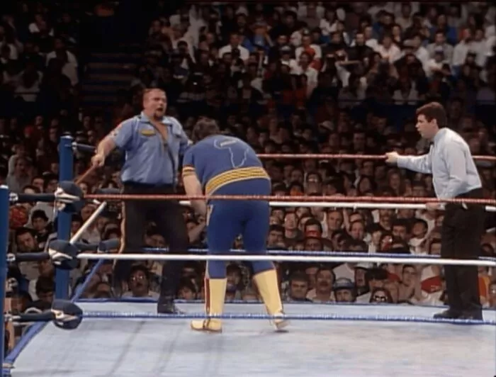 Akeem reels after a hard Big Boss Man shot at WrestleMania VI