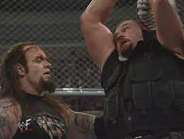 The Undertaker assesses a 'hanging' Big Boss Man in their ridiculous Hell in a Cell match at WrestleMania XV