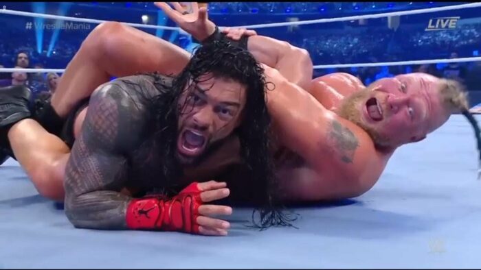 Brock Lesnar has Roman Reigns trapped in an armbar at WrestleMania 38