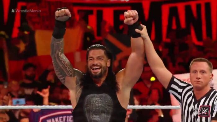 Roman Reigns has his arm raised at WrestleMania 35