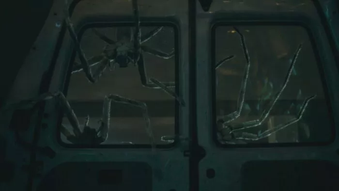 Spiders infiltrate a van door window in Infested.