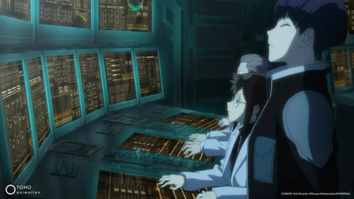 People in front of keyboards and monitors