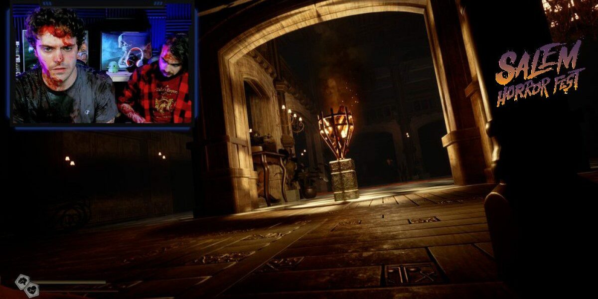 Two men covered in blood are seen in the top left of the screen while the rest of the image reveals a bloodstained corridoor and fountain in a massive marble foyer.