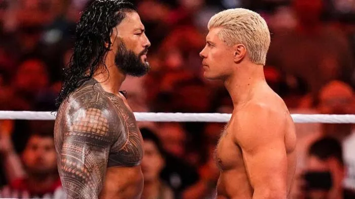 Roman Reigns facing off against Cody Rhodes in the ring