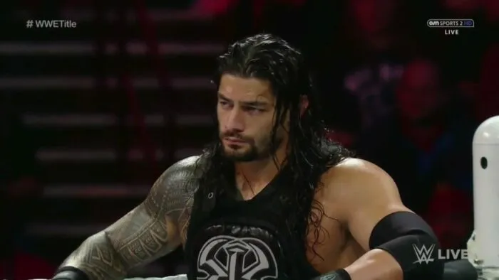Roman Reigns resting his arms on the ropes, stood in the corner of the ring