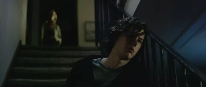 A boy sitting on a staircase