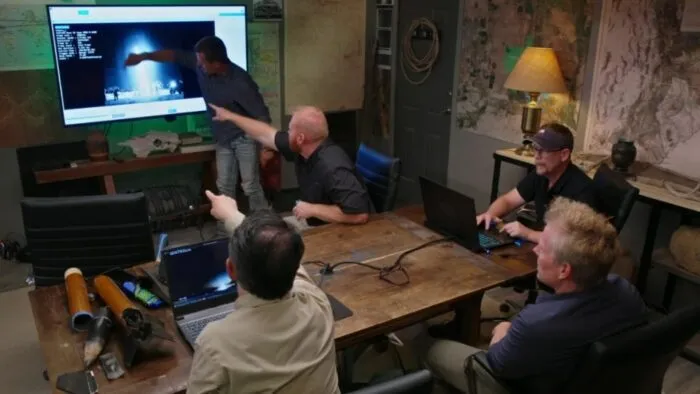 The team looks at a video in the Command Center