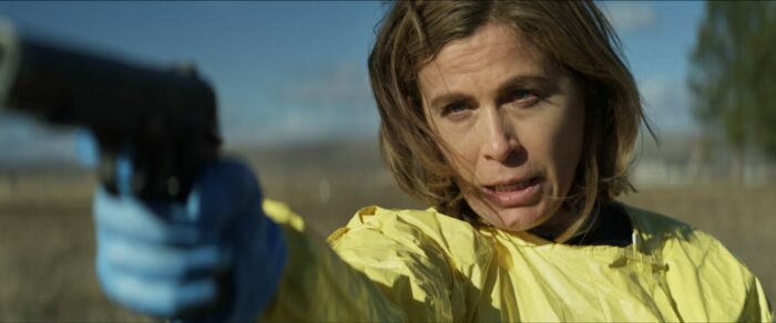 A woman in a hazmat suit points a gun in NEW LIFE