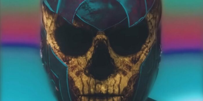 A skull-faced man looks intensely at the screen in AGGRO DR1FT. 
