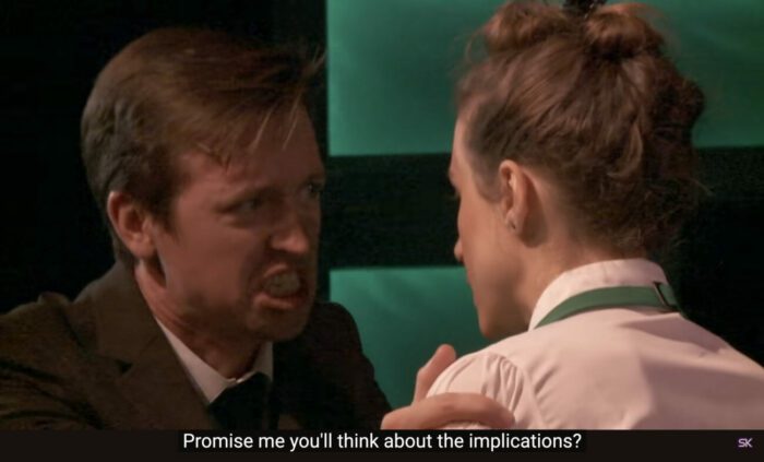 Paul Matthews (Jon Matteson) exclaims to Emma Perkins (Laura Lopez), "Promise me you'll think about the implications?" in the musical, "The Guy Who Didn't Like Musicals."
