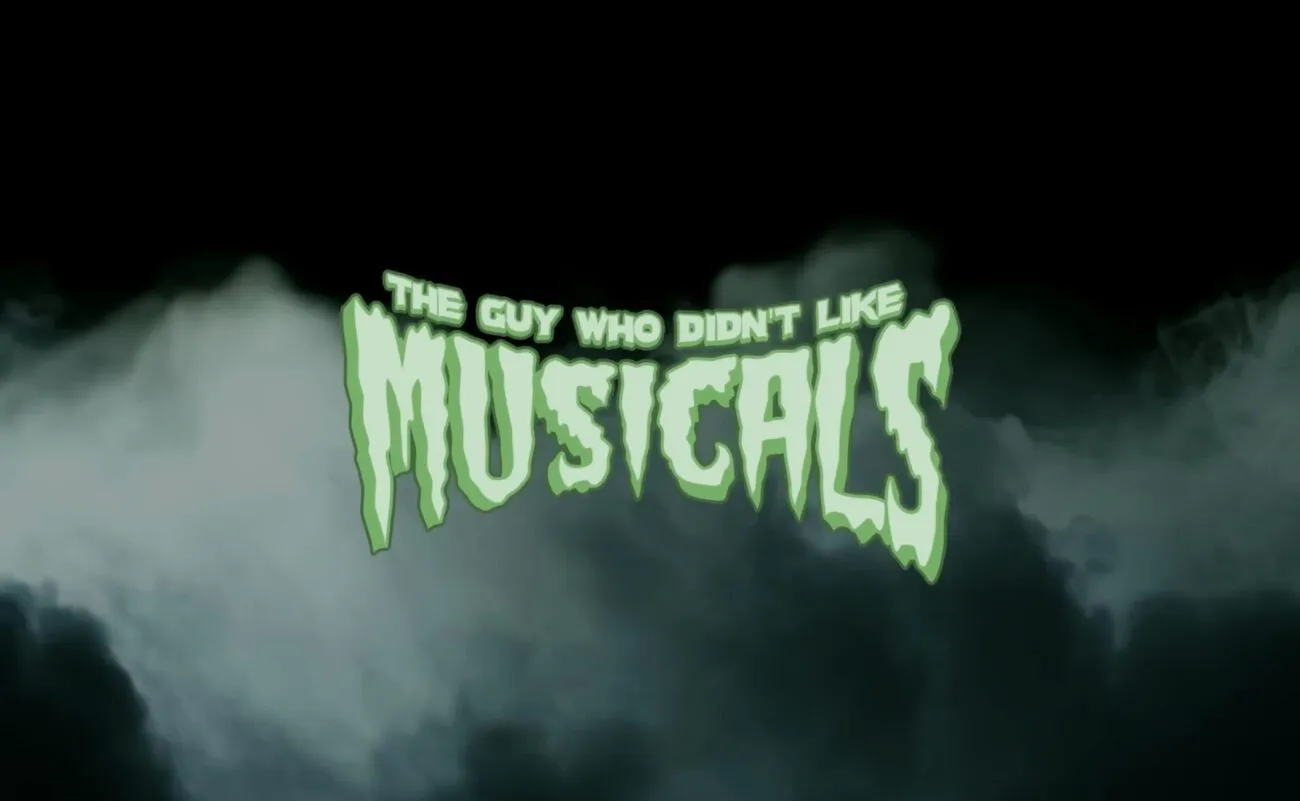 Green, spooky letters with green smoke billowing behind them spell the title, "The Guy Who Didn't Like Musicals."