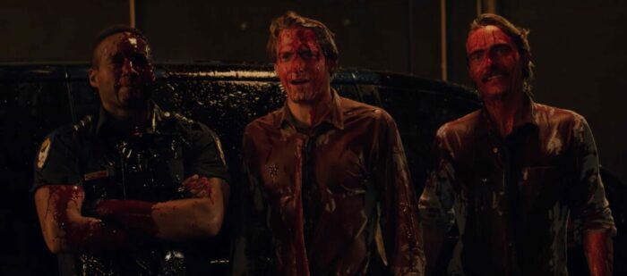 Three men covered in blood
