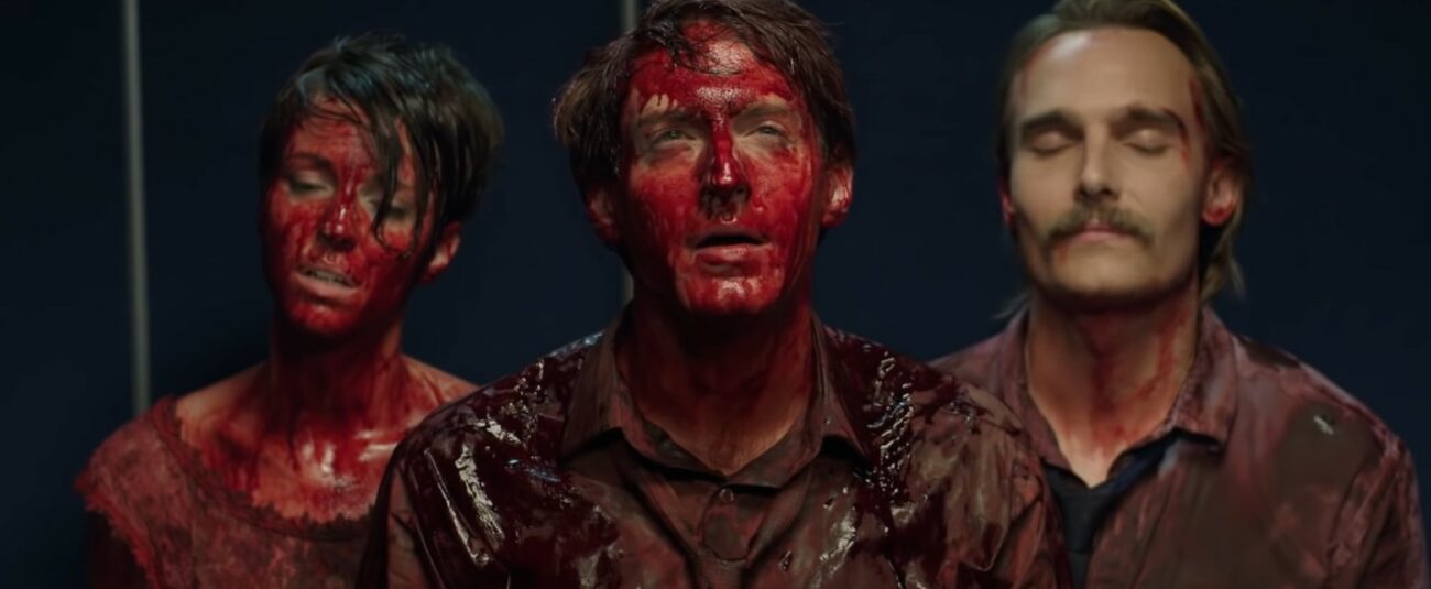 Three people covered in blood