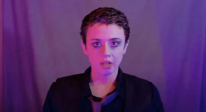 a woman with running mascara looks blankly into the camera in Faceless After Dark