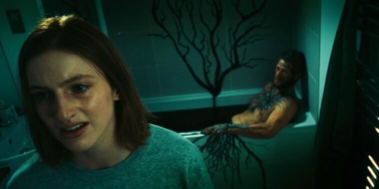 A woman and her monster lover in a bathroom