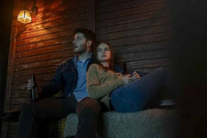 Two people sitting on a porch