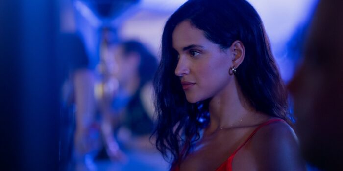 a close up of Adria Arjona in Hit Man, looking offscreen.