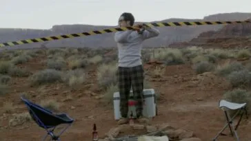 A man measuring the distance between two poles