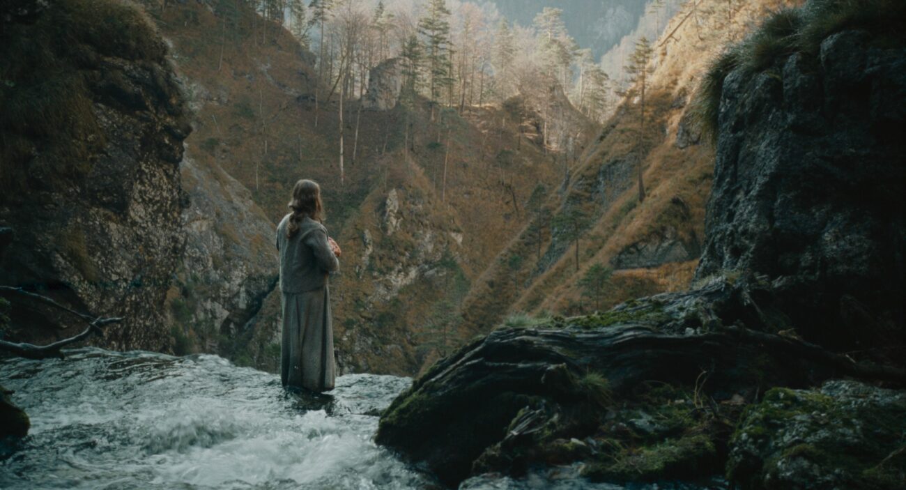 A woman at the edge of a waterfall