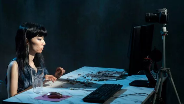 A woman sitting at a dirty table