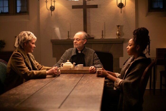 A priest and two women talking