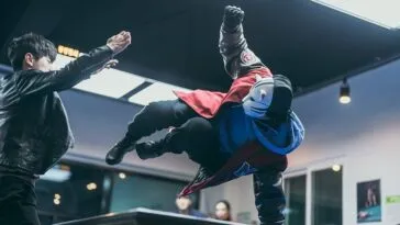 A masked hero kicking a bad guy