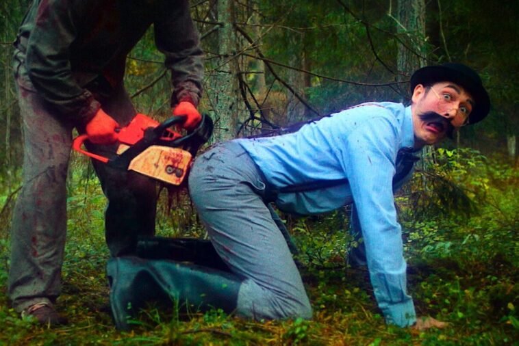 A well dressed man with a bowler cap and a mustache is shown on all fours in a forest propelling blood from his rear as another unseen man shoves a chainsaw up his keister
