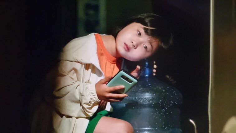 A girl listening to rice wine in a bottle