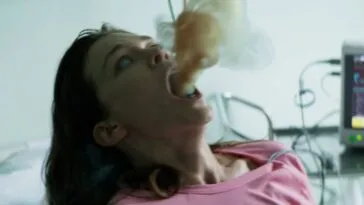 A woman in a hospital bed expels smoke.