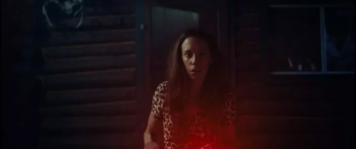 A woman looking into the camera looks surprised.