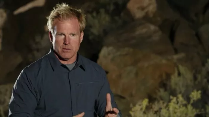 Dr. Travis Taylor stands in front of the Mesa at night