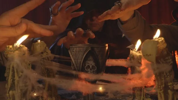 People putting their hands over a cup