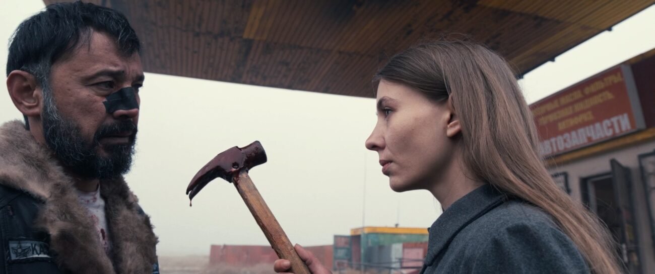 A man and a woman holding a hammer