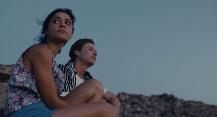 A man and a woman sitting outside