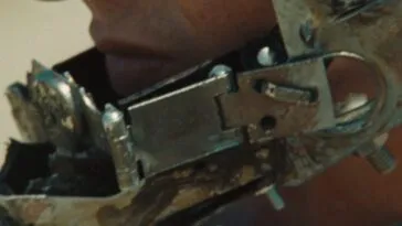 A metalic device is attached to the face of an unknown person.