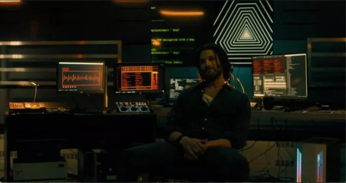 A man sitting in front of science equipment