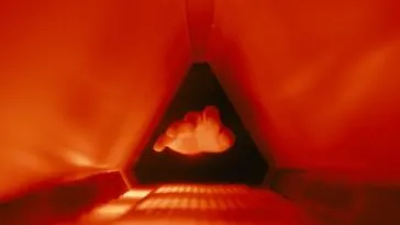 A hand entering a small chamber