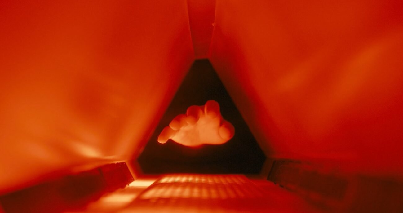 A hand entering a small chamber