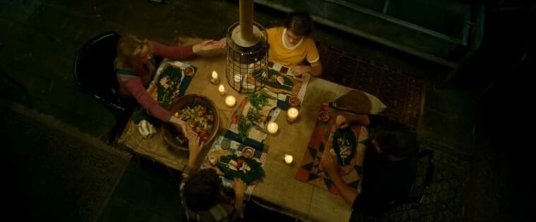 A family holding hands over the dinner table