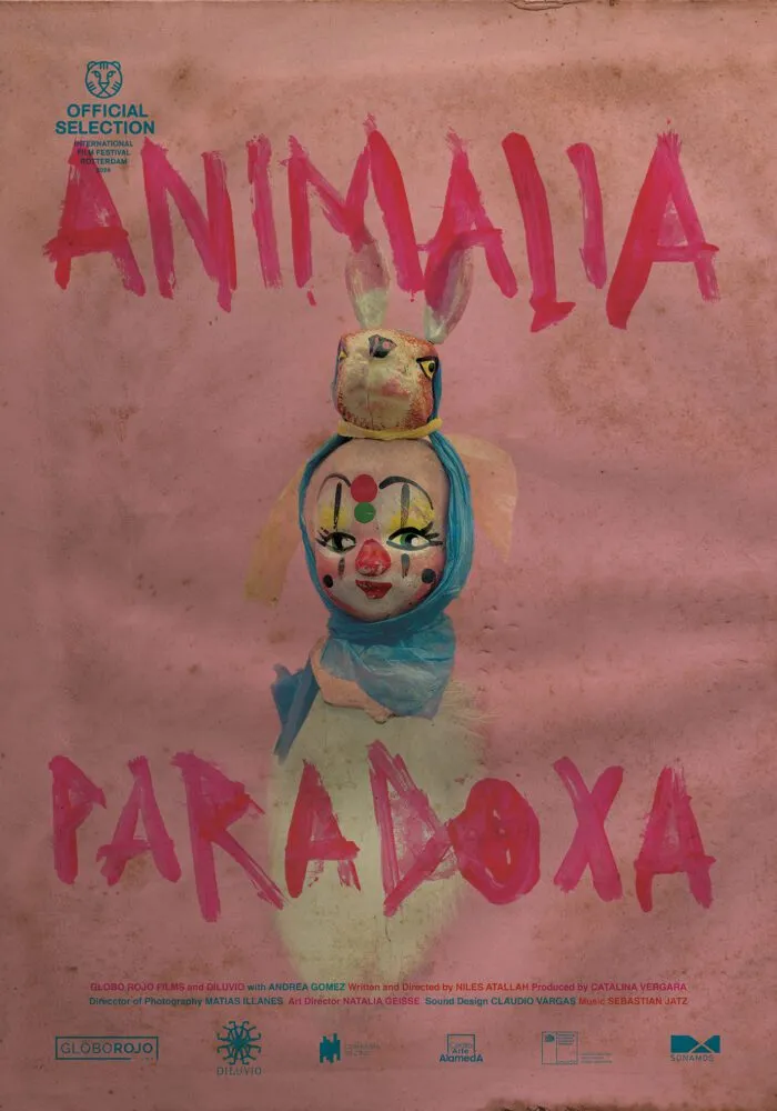 The poster for Animalia Paradoxa is pink and shows a watercolor painting of a small clownish figurine with a bunny mask on the top of its head.