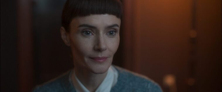 A woman with a slight smile