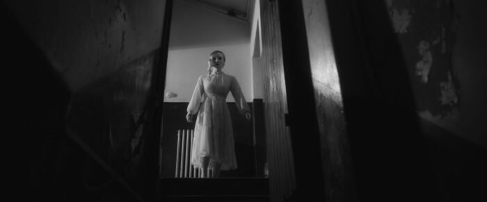 A woman at the top of a staircase