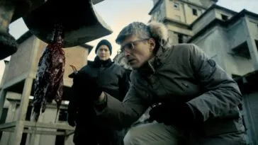 People examining a bloody drill