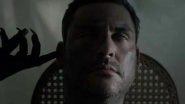 A demonic hand touching a man's face